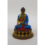 A Sino Tibetan painted moulded glass figure of Buddha seated on a lotus throne, engraved 4 character
