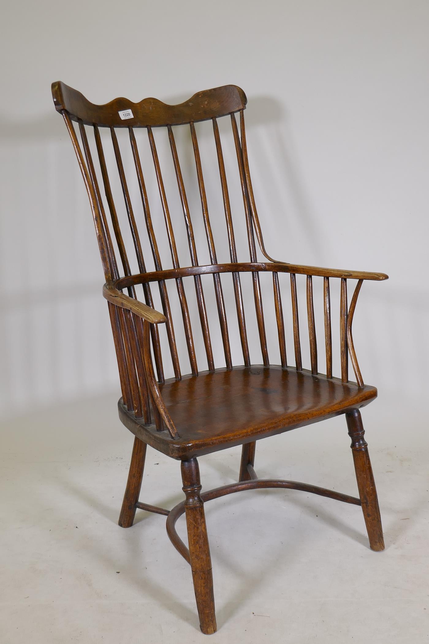 Early C19th Windsor comb back elbow chair with crinoline stretcher, raised on turned supports