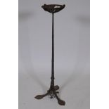 An antique Arts & Crafts style wrought iron stand with petal shaped dish, 28" high