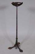 An antique Arts & Crafts style wrought iron stand with petal shaped dish, 28" high