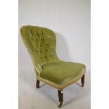 A Victorian balloon back nursing chair, raised on turned supports with brass castors