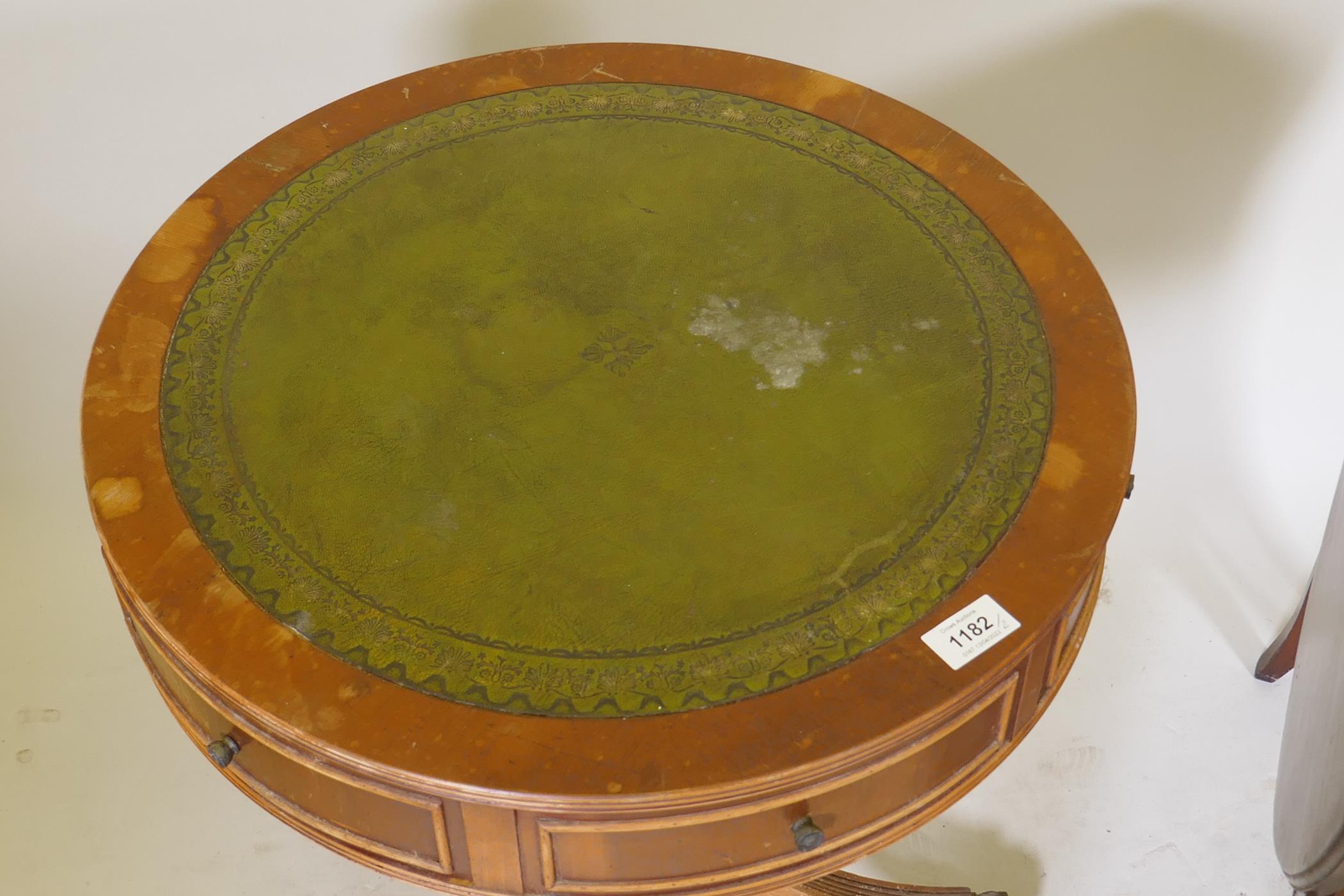 A small yew wood drum table with inset leather top, two true and four false drawers, raised on - Image 3 of 4