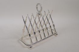 A silver plated letter / toast rack formed as a pair of rifles, 8" long