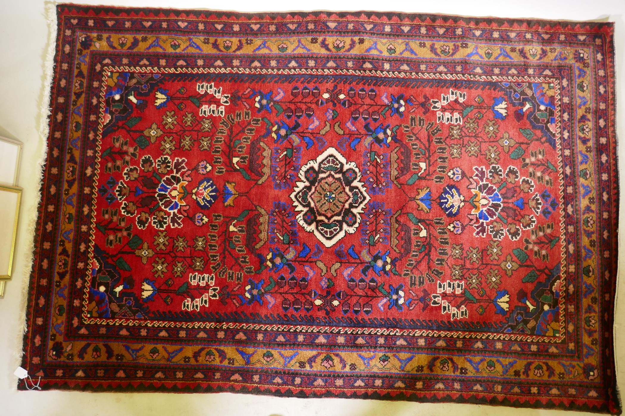 An oriental Hamadan wool carpet with medallion design on a red field, 82" x 54" - Image 2 of 3