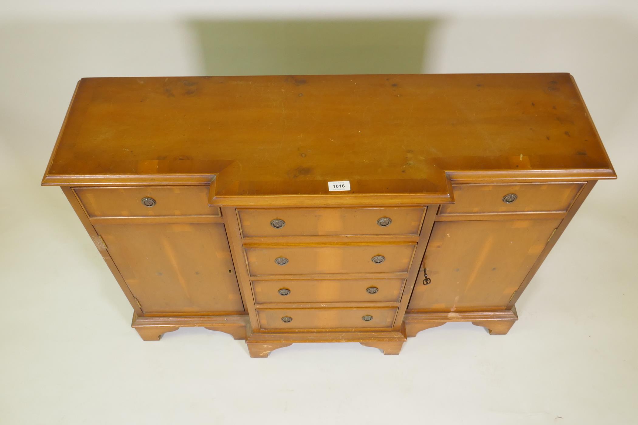 A small yew wood breakfront side cabinet with three drawers over two cupboards flanking a flight - Image 3 of 3