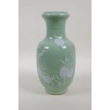 A celadon glazed porcelain vase with raised peach and bat decoration, Chinese Qianlong seal mark