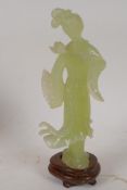 A carved greenstone figure of a Chinese lady, on a hardwood base, 8" high