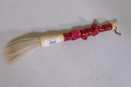 A Chinese paint brush with coral and bone handle, 11" long