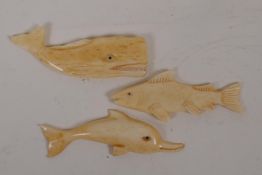 Three carved bone marine figures, dolphin, whale and fish, 3" long