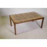 A mid century teak coffee table with inset tile top, 41" x 25" x 17"