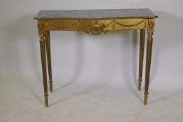 A mid century giltwood and composition console table with faux marble top, raised on fluted