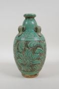 A Chinese Song style pottery vase with four lug handles and chased lotus flower decoration, 9" high