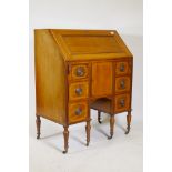 A Victorian walnut bureau with boxwood stringing, the fall front with a fitted interior, above six