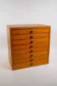 A ply eight drawer collectors' cabinet, the drawers with compartments, 12½" x 8", 12½" high