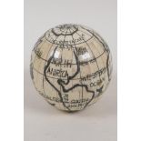 A bone globe, opening to reveal a compass, 3" diameter