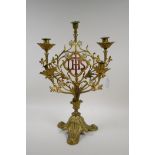 A five branch gilt and painted metal candelabra decorated with a crucifix and the monogram IHS,