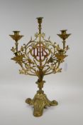 A five branch gilt and painted metal candelabra decorated with a crucifix and the monogram IHS,