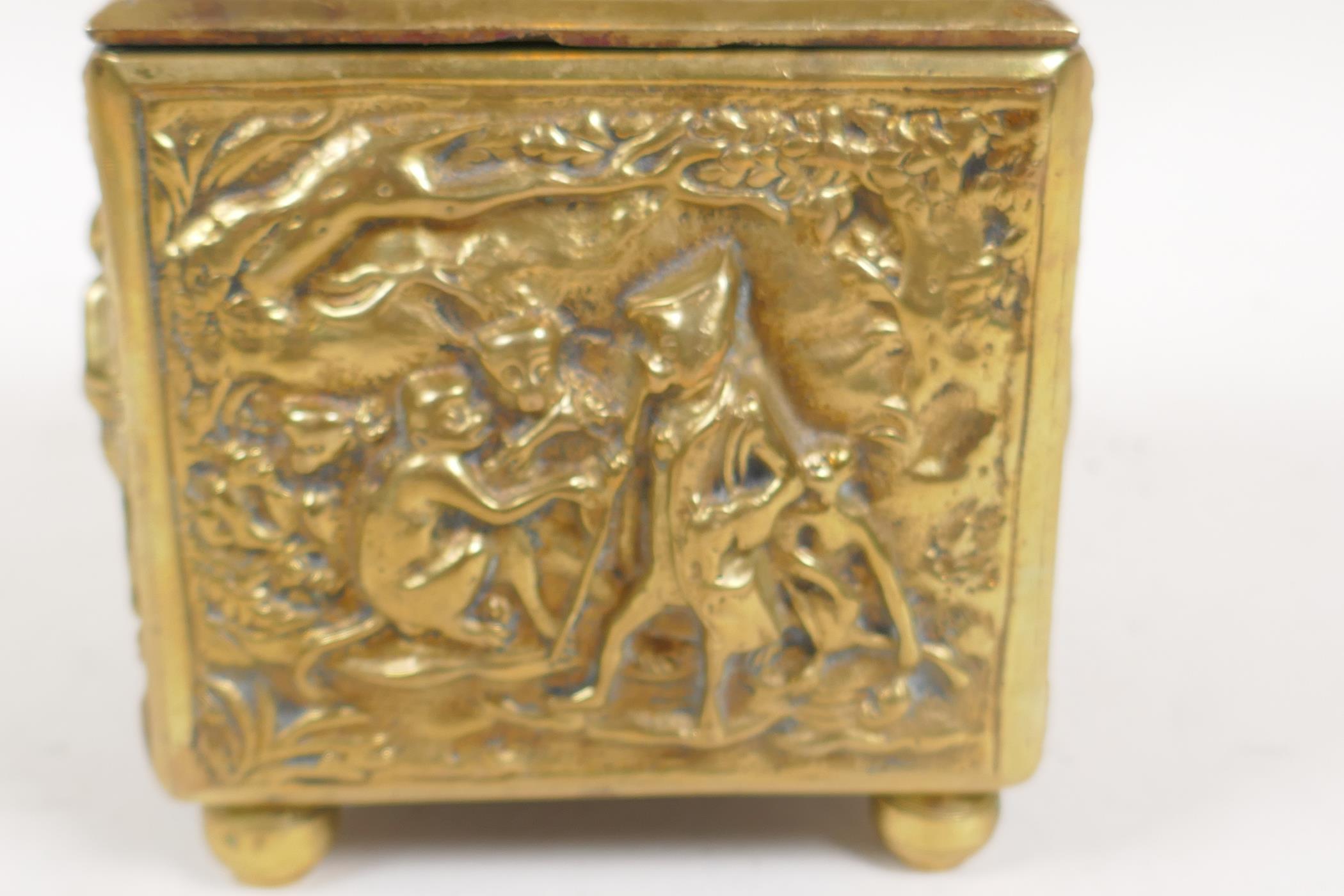 A late C18th/early C19th Dutch brass tobacco box embossed with a scene of a travelling monkey - Image 2 of 4