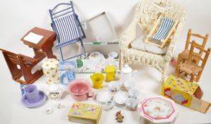 A quantity of doll related items to include furniture, tea sets, small dolls etc