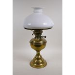An antique British made brass oil lamp with a glass shade, 19" high