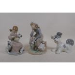 Two Lladro porcelain figures of girls with dogs and dolls, and another Lladro figure of a dog,