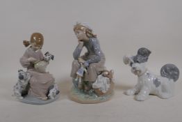 Two Lladro porcelain figures of girls with dogs and dolls, and another Lladro figure of a dog,