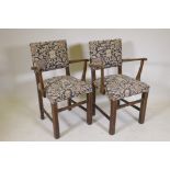 A pair of oak open arm chairs