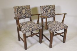 A pair of oak open arm chairs