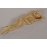 A Japanese bone okimono carved as a female nude, 3½" long