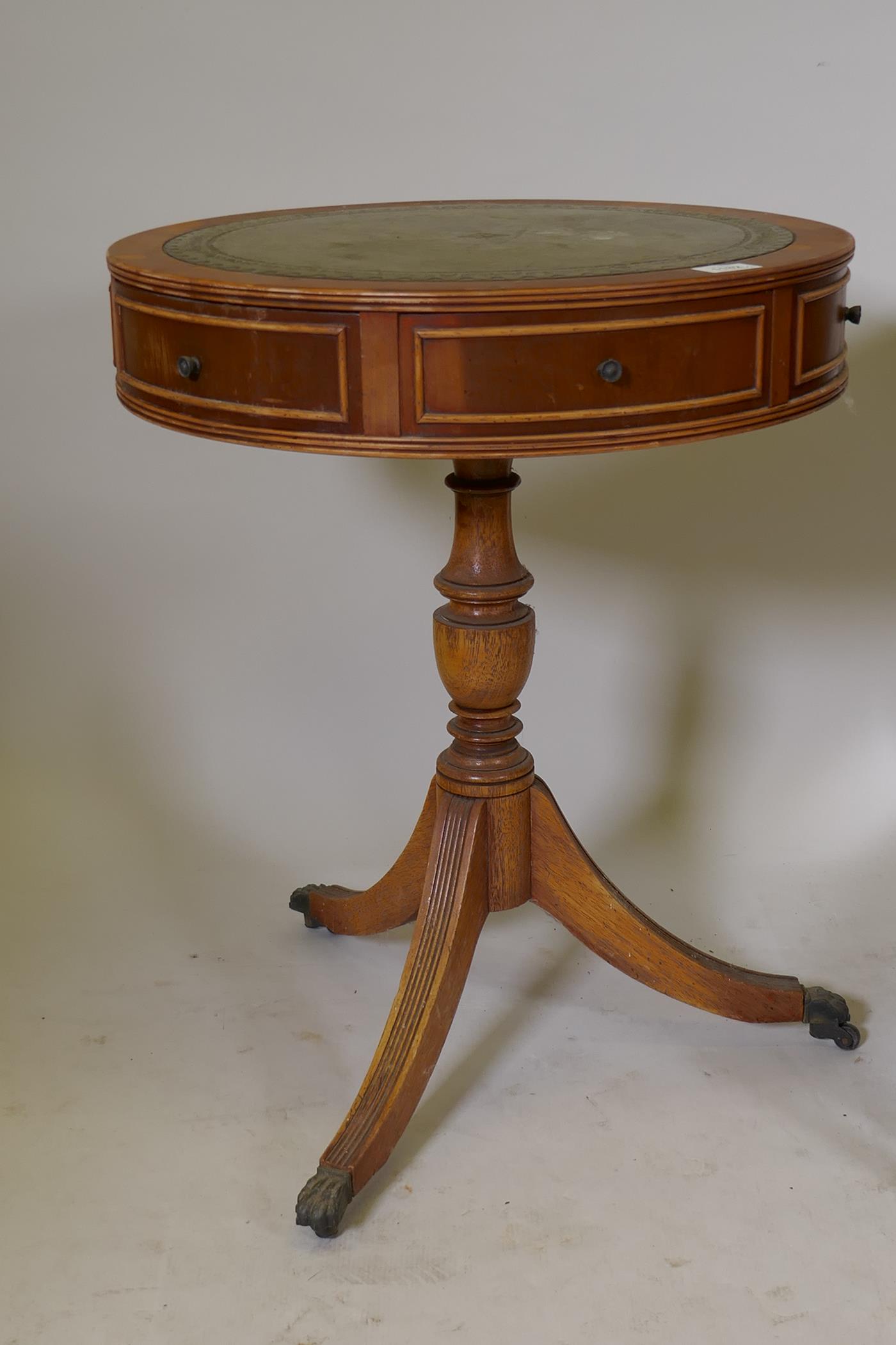 A small yew wood drum table with inset leather top, two true and four false drawers, raised on - Image 2 of 4