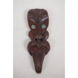 A Maori carved hardwood wall mask with abalone eyes, 9½"
