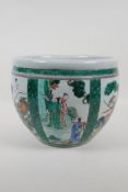 A famille vert porcelain jardiniere with decorative panels depicting figures in a landscape and