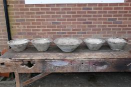 Five mid century conical concrete garden planters of varying sizes, all with bark effect