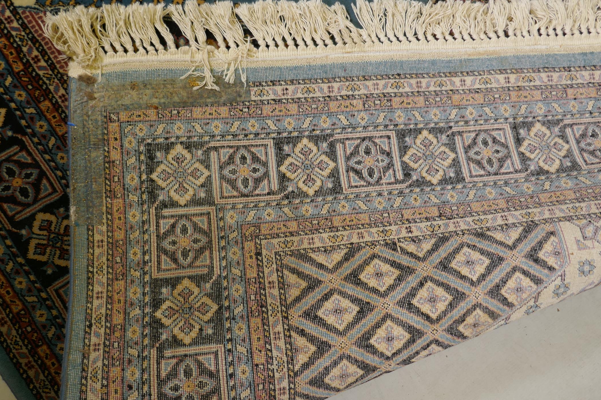 An oriental blue ground wool rug, decorated with a geometric medallion design, 63" x 99" - Image 4 of 4