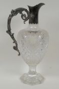 A Victorian pedestal cut glass claret jug with hallmarked silver handle and top, bears makers mark