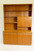 A McIntosh mid century teak side cabinet in two sections, the illuminated upper with open shelves