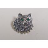 A sterling silver cat's head brooch with emerald set eyes