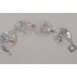 A four panel mother of pearl disc bracelet set with silver bats, 8" long