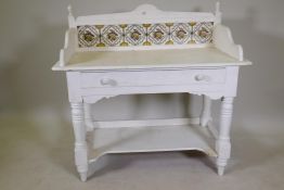 A Victorian pine washstand with three quarter gallery top and tiled back, single drawer and shaped