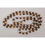 A string of tiger's eye and pearl beads, 46" long