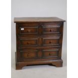 Ipswich oak chest of two over two drawers with pegged joints and moulded front drawers, raised on