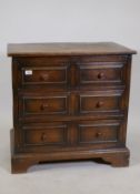 Ipswich oak chest of two over two drawers with pegged joints and moulded front drawers, raised on