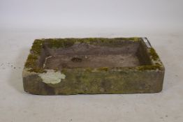 An antique stone basin, with drain hole, 19" x 31" x 6"