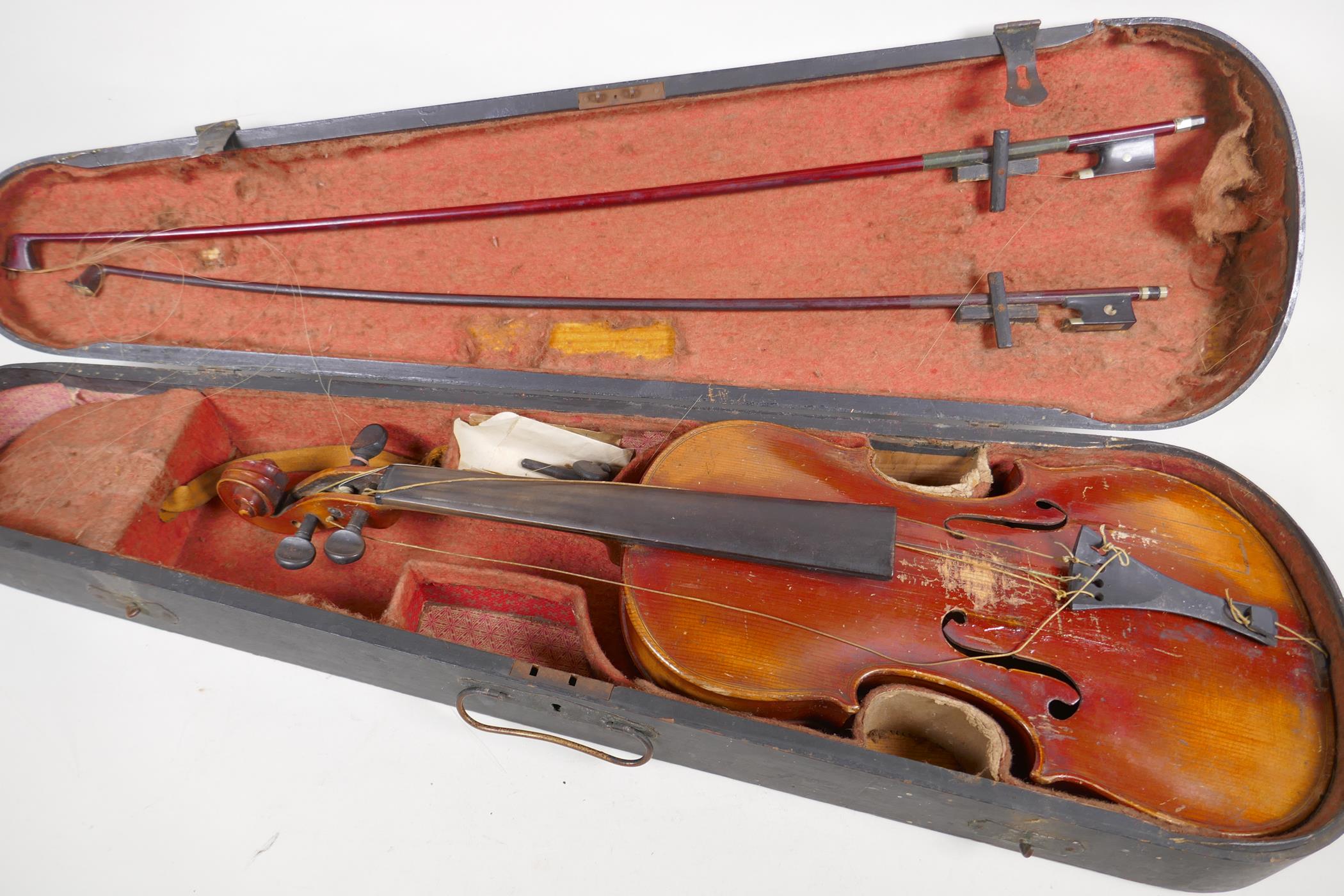 A vintage violin, 23½" long, with two bows, one marked Japan with chrysanthemum, in a fitted