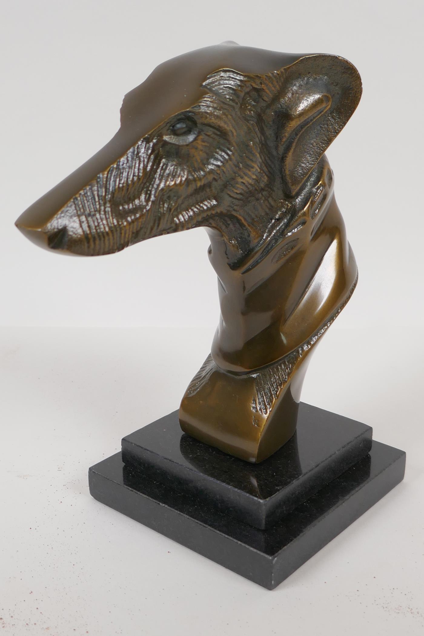 A bronze bust head of a greyhound on a stepped marble base, 9" high