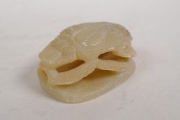 An Egyptian carved and pierced soapstone scarab toggle, 2" x 3"