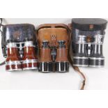 Three pairs of vintage binoculars in leather cases
