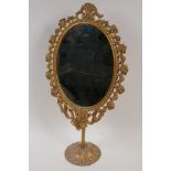 A cast brass framed dressing table mirror on pedestal stand, 17½" high