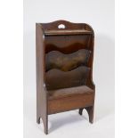 A 1930s oak magazine rack/canterbury, with single drawer and two compartments, labelled Pittocks,