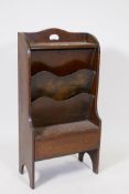 A 1930s oak magazine rack/canterbury, with single drawer and two compartments, labelled Pittocks,